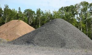 sand and gravel piles moved by industrial hose