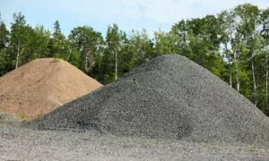sand and gravel piles moved by industrial hose