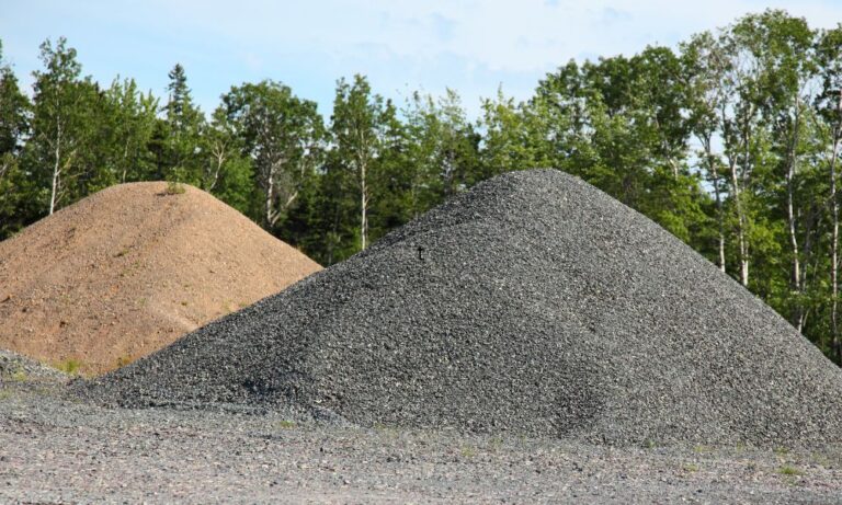 sand and gravel piles moved by industrial hose